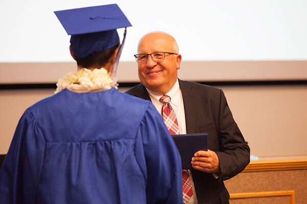 student receiving diploma