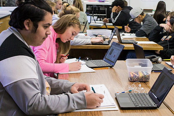 students work on laptops