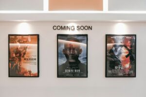 Picture of three movie posters on a white wall with the words "Coming soon" above.