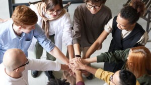 group of diverse people putting hands together