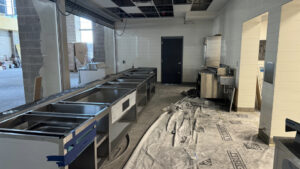 Shoreline Middle kitchen with sinks and cardboard boxes.