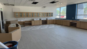 A wideshot of a Shoreline middle classroom; cabinetry, tiling, and a window, all complete.