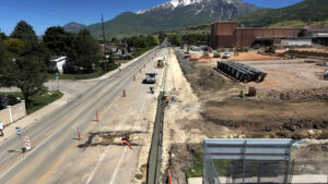 drone shot of Canyon Road with a torn-out sidewalk and a mountain in the background