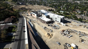 A long drone shot capturing the dirt lot surrounding the site pre-landscaping.