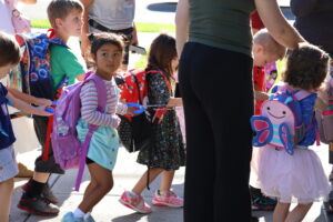 A group of new preschoolers wait for class to start.