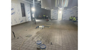 A landscape shot of the Wasatch Elementary Kitchen; the image is angled downwards to show brown, hand-span-sized tiles.