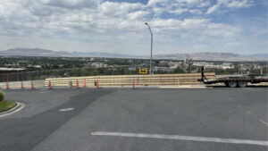 A medium shot of the road above the Wasatch Elementary school. Jersey-styled concrete barricades line the student walkway, protecting them from traffic.