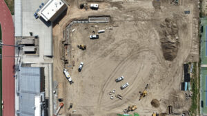 Bird's eye view of the Softball dug-out. In the top right-hand corner of the lot, one can see the concrete dug-out, buried in the dirt, as well as rebar sticking from the ground, making the square for where the pitching mound and fence will be installed. 