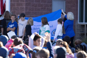 Blue ribbon flag being raised