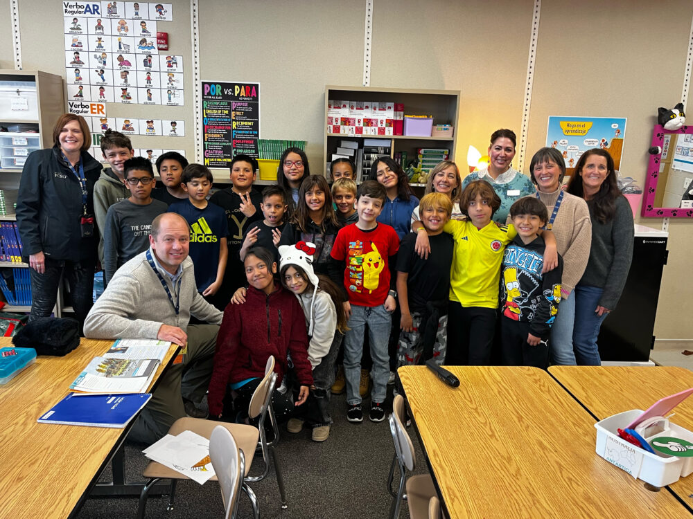 Teacher Brenda Clegg stands in the center of the Foundation group, including Superintendent Dau and Principal Wolfe. 