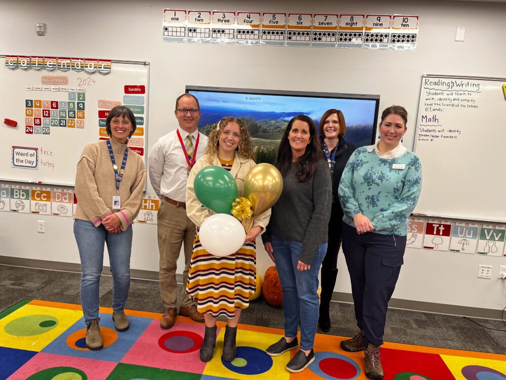 Teacher Alice Ficklin stands in the center of the Foundation group, including Superintendent Dau and Principal Hansen. 