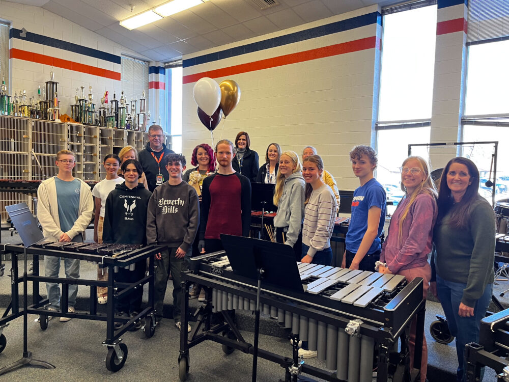 Dahlia Bone stands in the center of a group of students and the Foundation, including Superintendent Dau. 