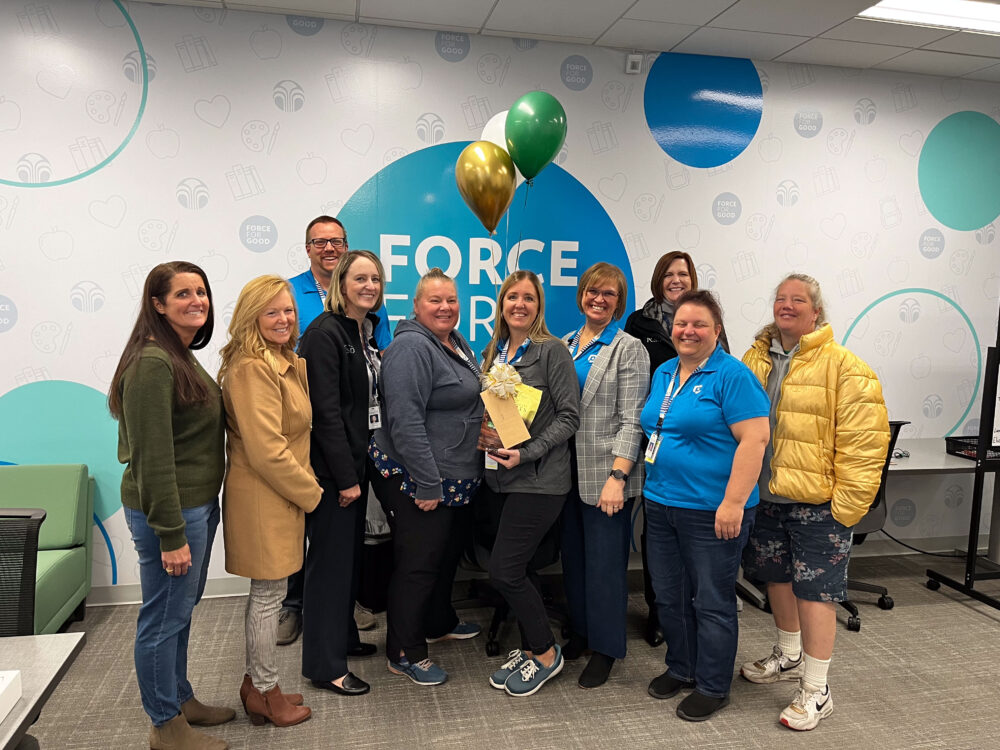 Teacher Erica Persson stands in the center of the Foundation group, including Superintendent Dau and CAPS Director Judy Rose. 