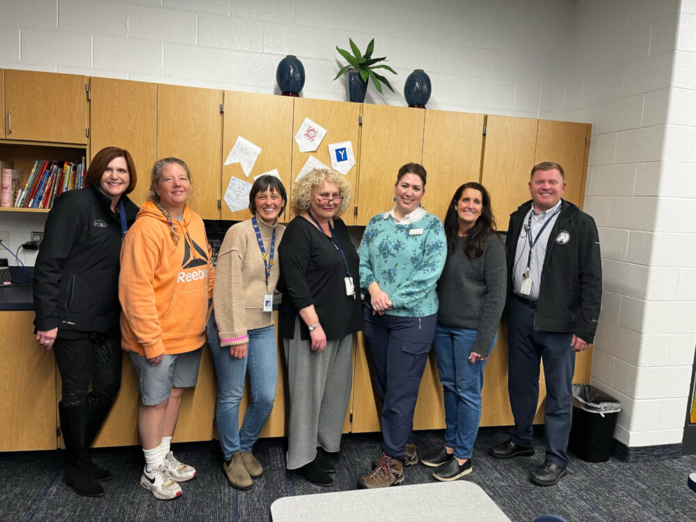 TeacherKimberly Boyd stands in the center of the Foundation group, including Superintendent Dau and Principal Hirshi. 