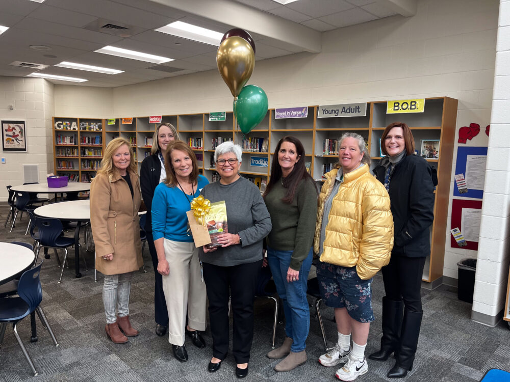 Librarian Leticia Meibos stands in the center of the Foundation group, including Superintendent Dau and Principal Brock. 