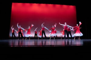 Dancers pose on a stage.