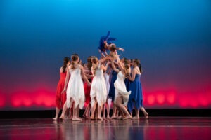 Dancers pose on a stage.