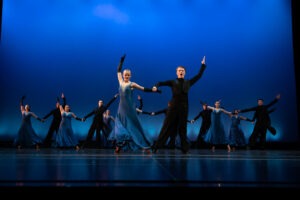 Dancers pose on a stage.