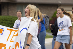 A girl holding a banner is cheering.