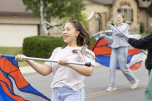 A girl twirls a flag.